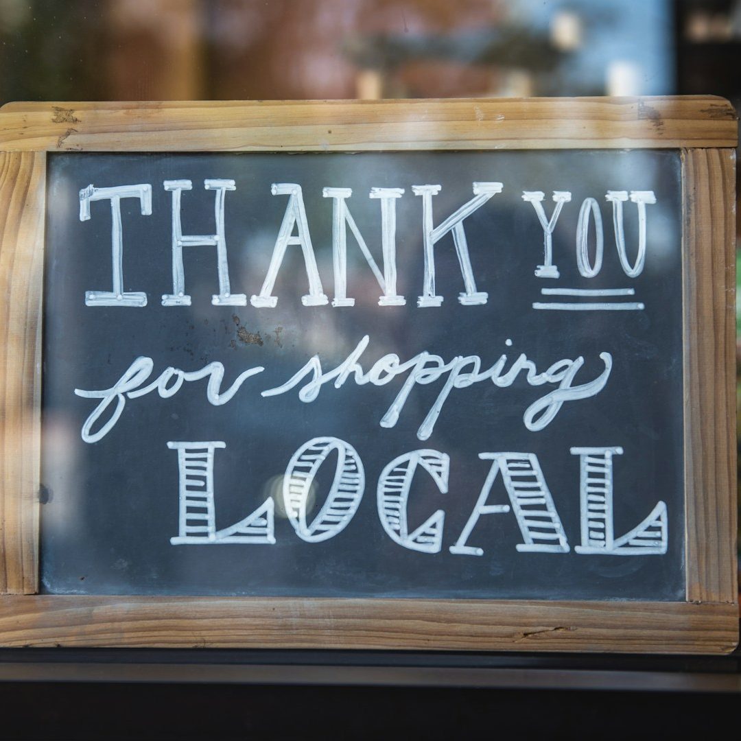 Chalkboard sign that says "Thank you for shopping local."